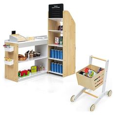 a toy shopping cart with food in it next to an open bookcase and shelf