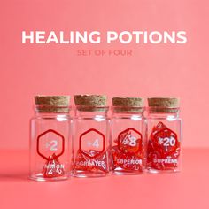 three glass jars with red dices in them on a pink background that says, healing potions set of four