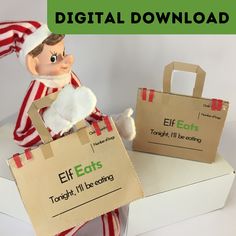 an elf is sitting on top of a box with two bags in front of him