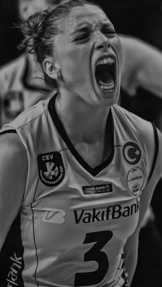 a black and white photo of a female basketball player with her mouth open wide open