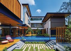 an outdoor swimming pool in the middle of a house with wooden sidings and steps leading up to it