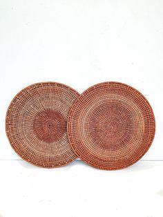 two brown woven plates sitting next to each other