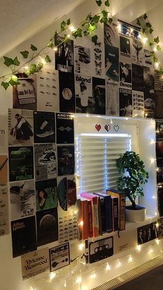 a room with books, plants and lights on the wall