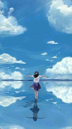 a girl is standing in the water with her arms spread out and looking at the sky