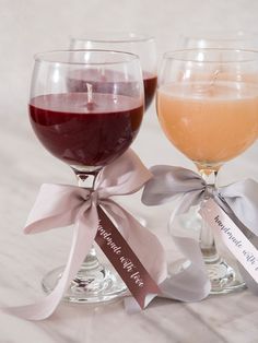 two wine glasses filled with different colored liquid