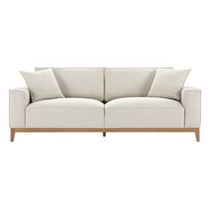 a white couch with two pillows on the back and one pillow on the side, in front of a white background