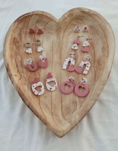 a heart shaped wooden plate with pink and white letters on it, including the number 60