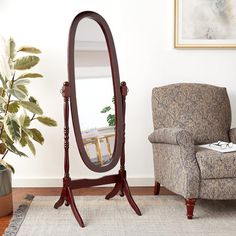 a mirror sitting on top of a wooden stand in a living room next to a chair