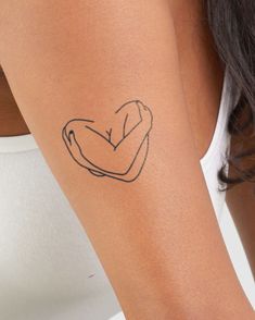 a woman's arm with a small tattoo on the left side of her arm