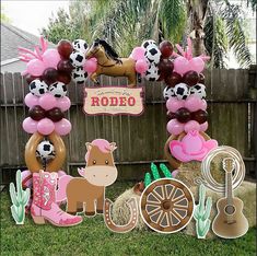 a birthday party with balloons and decorations in the shape of horses, cowgirls, cowboy boots