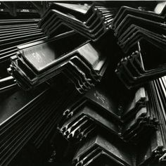 black and white photograph of steel bars stacked on top of each other