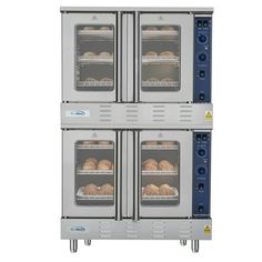 three ovens with food cooking in them on top of each other, one is open and the other two are closed