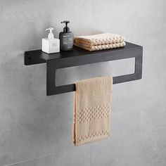 a bathroom shelf with towels and soap on it