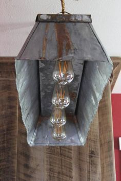 a metal light fixture hanging from the ceiling