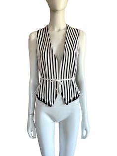 1990s Moschino Cheap and Chic black and white shoe laces stripe vest Ties at waist Lined Marked size 42 (IT) Best fit: S Made in Italy Condition: Very good (no particular flaw) Measurements (taken flat): Shoulders: 17 cm / 6,5" Armpits: about 41 cm / 16" Waist (adjustable): about 40 cm / 15,5" Front length: 56 cm / 22" Back length: 50 cm / 19,5" - -- CONDITION GLOSSARY -- -- DEADSTOCK: the item is new, never be worned and it still has the label tag. EXCELLENT: the item is like new, it has no fla Sleeveless Vest With Vertical Stripes For Spring, Chic Striped Summer Vest, Chic Striped Spring Vest, Spring Workwear Vest With Vertical Stripes, Chic Fitted Striped Vest, Striped Vests, Vest And Tie, Moschino Cheap And Chic, Black And White Shoes