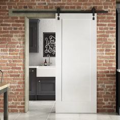 an open door leading to a bathroom with brick walls