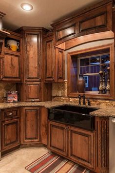 a kitchen with wooden cabinets and granite counter tops