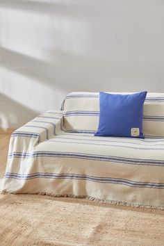 a white couch with blue pillows on it