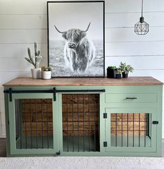 a cow is standing in the middle of a room next to a dog kennel