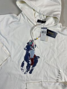 a white hoodie with an image of a bear on it