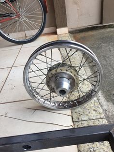 a bike wheel on the ground next to a bicycle tire with spokes in it