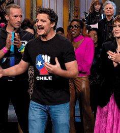 a man standing in front of a group of people on the set of snl