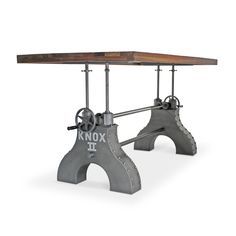 an iron and wood work bench with two benches on it's legs, the bench has