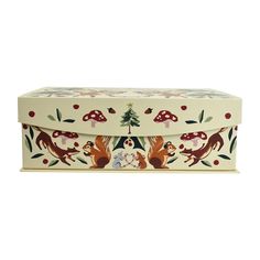 a white box with foxes and mushrooms painted on the lid, sitting in front of a white background