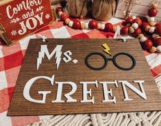 a wooden sign that says, mr and mrs green on it next to other items