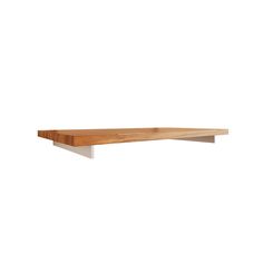 a wooden shelf sitting on top of a white wall