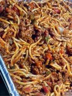 a pan filled with spaghetti and meat sauce