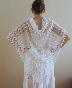 a woman wearing a white crocheted shawl