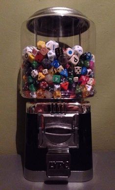 a gummy machine filled with lots of different types of dice and numbers on it