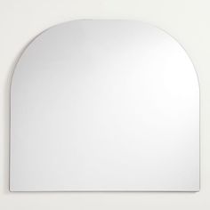 an oval shaped mirror mounted on the wall