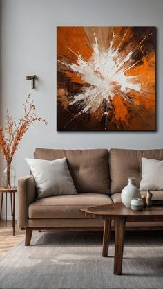 a living room filled with furniture and a painting on the wall above it's coffee table