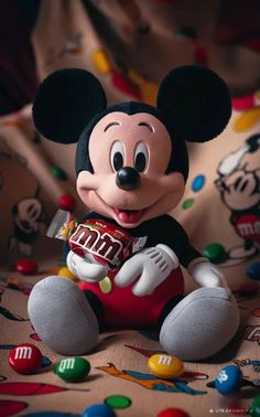 a mickey mouse holding a candy bar in his hand