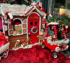 a christmas scene with teddy bears in a red car and a gingerbread house on display