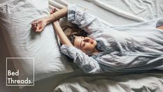 a woman laying on top of a bed covered in white sheets and pillows with the words bed threads above her head