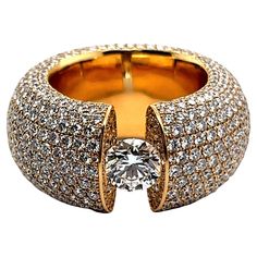 Boldly glamorous and fiercely sparkly. This pave diamond ring will light up any look! The word pavé comes from the French word to pave (a road) as the style resembles a cobblestone street and this unique ring is literally paved with diamonds. Softly rounded band of 18 Karat yellow gold is lavishly setted with an array of 829 brilliants of G-H colour and vs clarity totaling 10.00 carats. In the center of this shining canvas is an exquisite 1.02 carat brilliant. The diamond of rare white colour G Luxury Gold Plated Jewelry With Brilliant Cut, Luxury Yellow Gold Dazzling Jewelry, Luxury Vintage Jewelry With Pave Setting, Luxury Brilliant Diamond Ring, Luxury Sparkling Diamond Promise Ring, Glamorous Diamond Ring With Pave Setting, Luxury Sparkling Diamond White Ring, Big Diamond Engagement Rings, Buccellati Jewelry