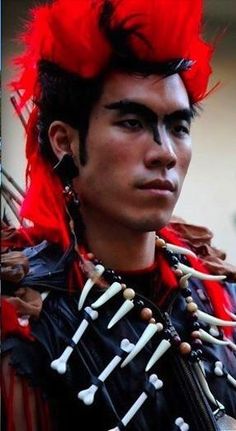 a man with red hair and skeleton decorations on his head