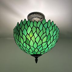 a green lamp hanging from the ceiling in a room