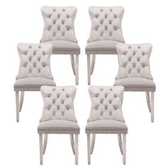 six white upholstered chairs with buttons on them