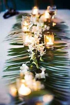 a long table with candles and flowers on it