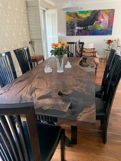 a wooden table with black chairs around it