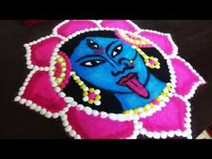 a decorated blue face on a pink flower