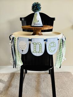 a chair that has a table with a cake on it and a hat on top