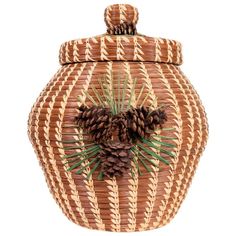 a large woven basket with pine cones on the top and green leaves in the bottom