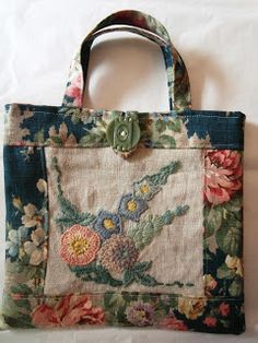 a handbag with flowers on it sitting on a white surface