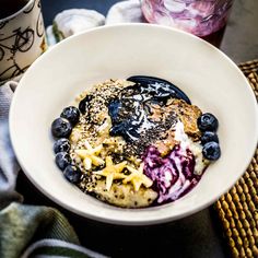 a white bowl filled with blueberries and granola