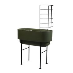 a green planter sitting on top of a metal stand